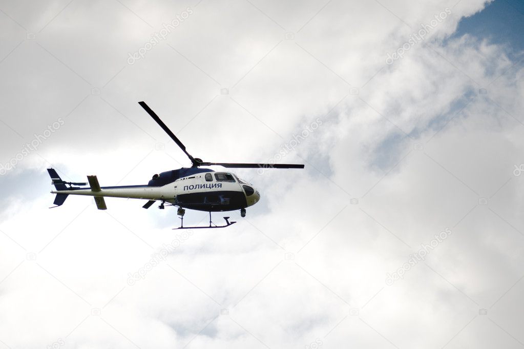Police helicopter on the cloudy sky