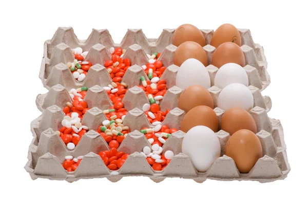 Egg and medical tablet on box — Stock Photo, Image