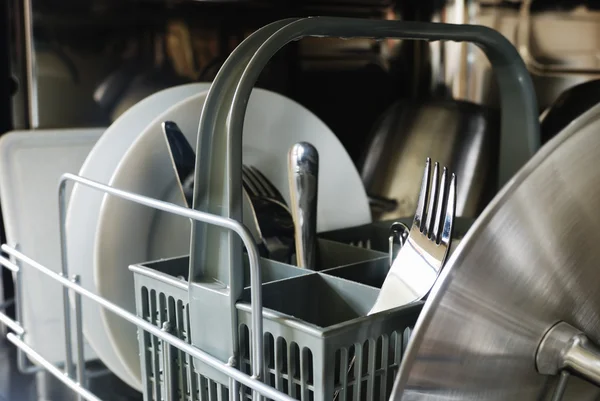 stock image Plates, forks, knives, in the dishwasher