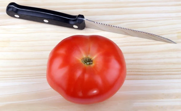 stock image Wood kitchen board with knife and tomato