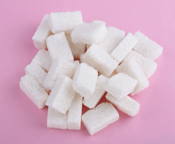 stock image Heap of sugar on pink background