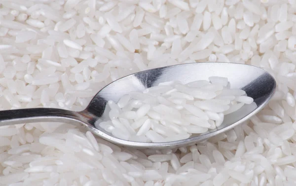 Rice food background and teaspoon — Stock Photo, Image