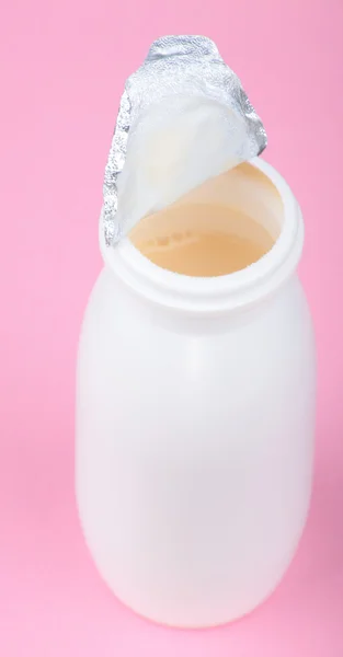White bottle on pink background — Stock Photo, Image