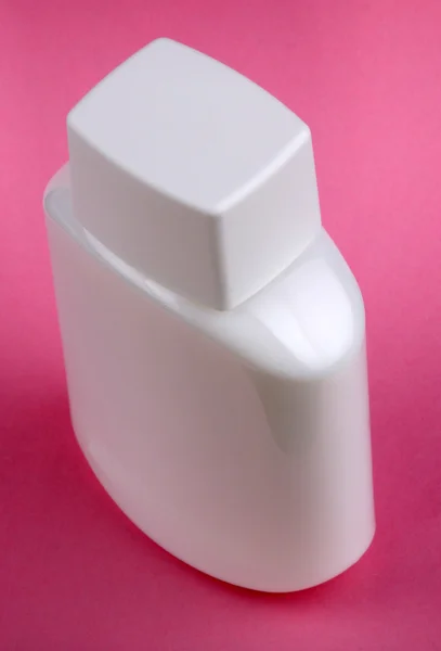 粉红色的背景上的香水瓶 — 图库照片