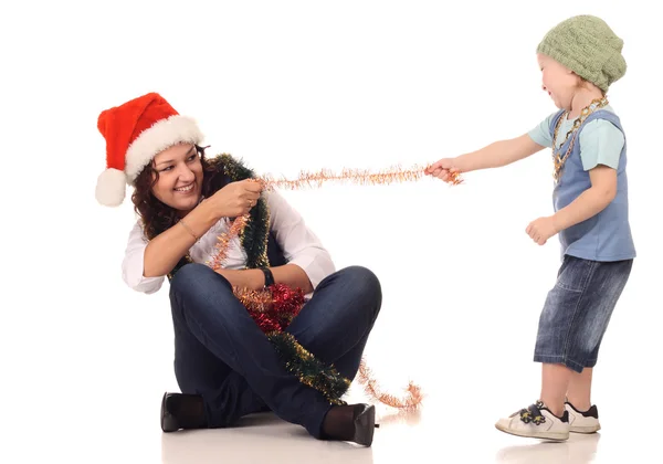 Girl in a santa hat playing with a boy — Stock Photo, Image