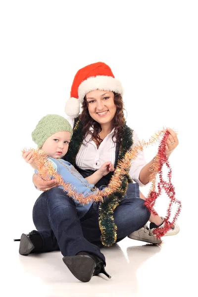 Chica en un sombrero de santa con un niño pequeño —  Fotos de Stock