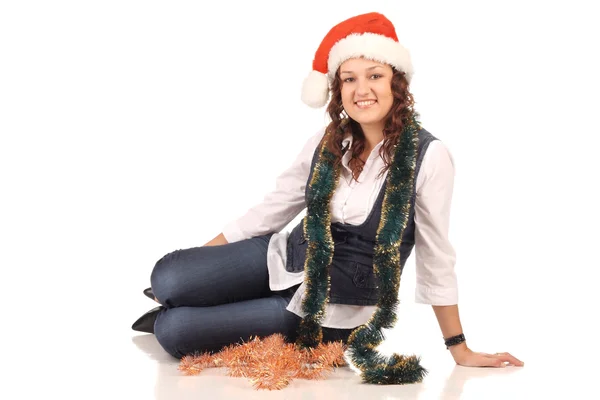 Girl in a santa hat with christmas decoration — Stock Photo, Image