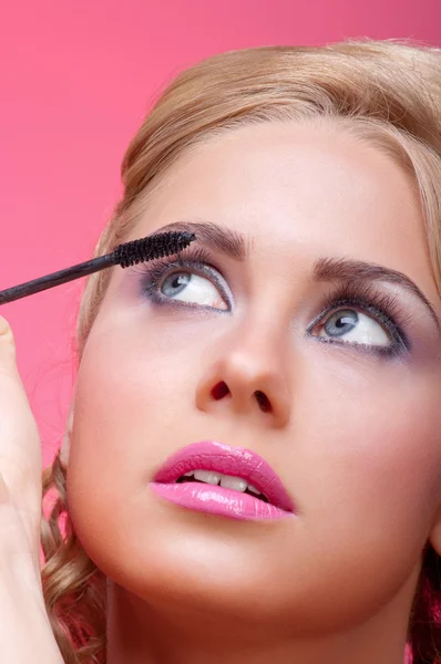 stock image Woman applying mascara on her eyelashes