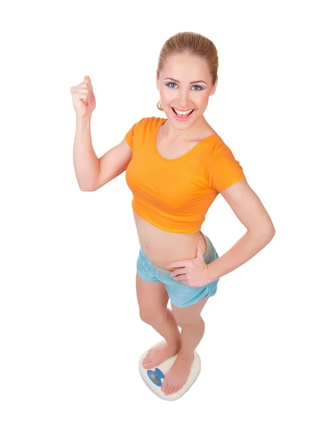 Young smiling woman on scales — Stock Photo, Image