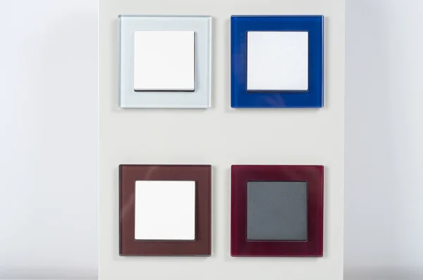 Interruptores de luz na parede com botão no quadro de vidro — Fotografia de Stock