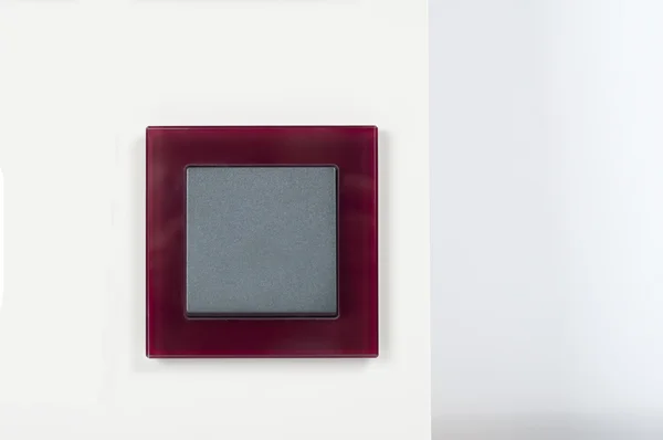 Interruptor de luz en la pared con botón gris en el marco de cristal —  Fotos de Stock