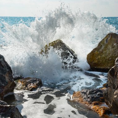 Storm. Big stone covered by waves. clipart