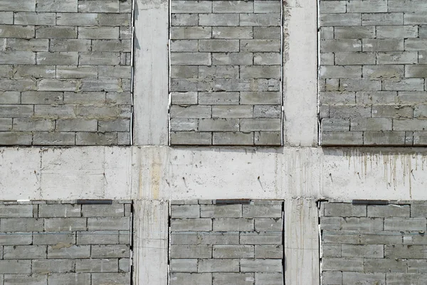 Una pared de ladrillos texturizados de construcción gris . —  Fotos de Stock