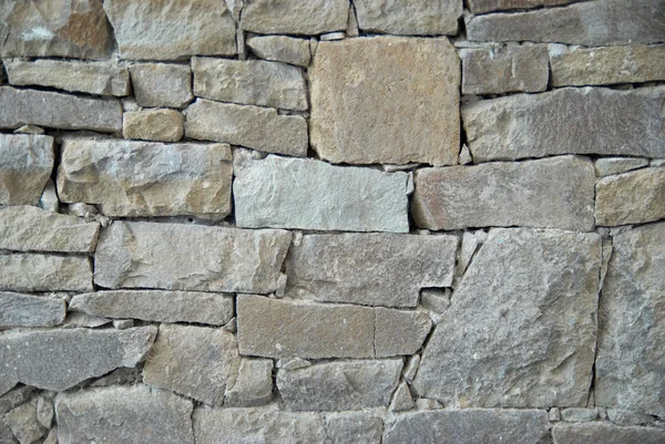 A wall of textured natural stones. — Stock Photo, Image