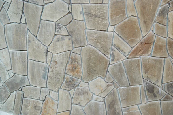 En vägg av texturerat naturliga stenar. — Stockfoto