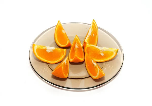 stock image Orange segments on the plate isolated on white.