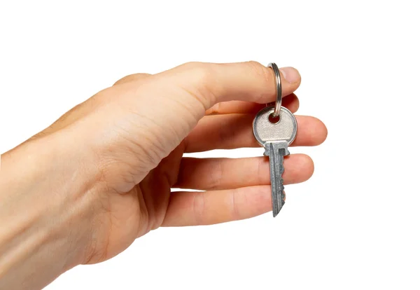 Silberner Schlüssel in einer Hand isoliert auf weiß. — Stockfoto