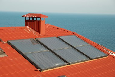 Alternative energy- solar system on the house roof. clipart