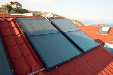 Alternative energy- solar system on the house roof. clipart