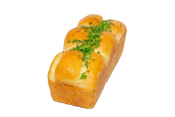 Gyllene färskt bröd med gröna isolerad på vit. — Stockfoto