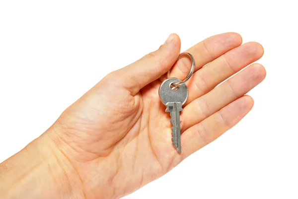 Silberner Schlüssel in einer Hand isoliert auf weiß. — Stockfoto