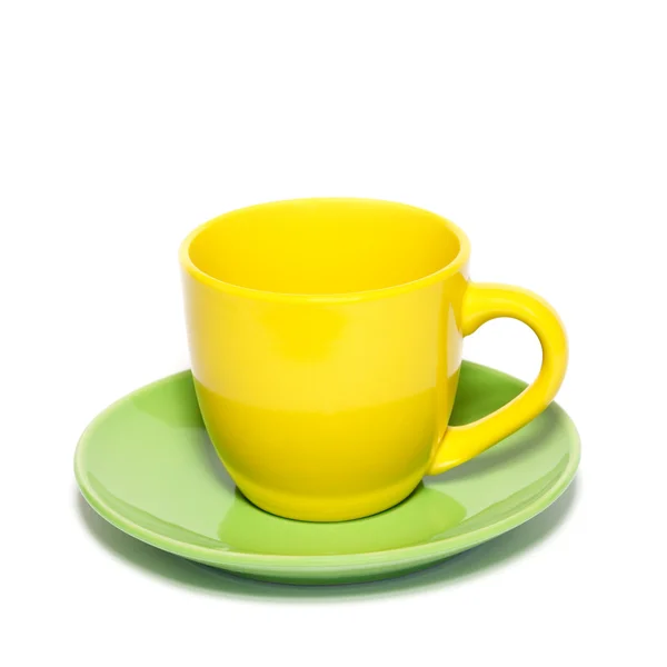 Colored teacup and saucer isolated on white. — Stock Photo, Image