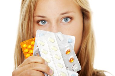 Young beautiful woman with pills. clipart