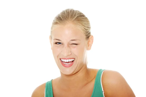 Happy young blond woman blinking. — Stock Photo, Image