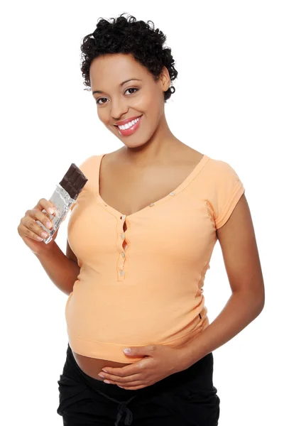 Pregnant woman eating chocolate — Stock Photo, Image