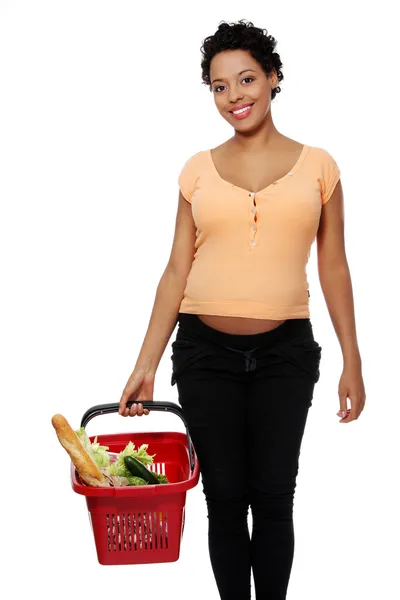 Pregnant woman with shopping basket — Stock Photo, Image