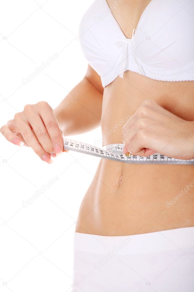 Pretty Caucasian woman measuring her waist measuring tape, Stock image