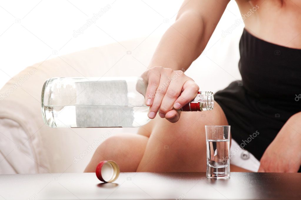 Woman in depression, drinking alcohol (vodka)