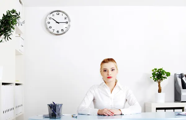 Blonde woman sitting in her office. — Stock Photo, Image