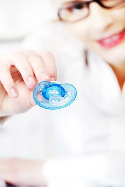 Stock image Businesswoman giving a dummy to her child in the office.