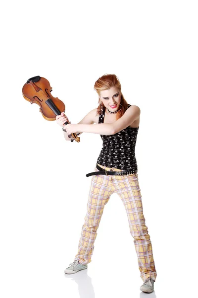 Angry punk girl intending to break her fiddle. — Stock Photo, Image