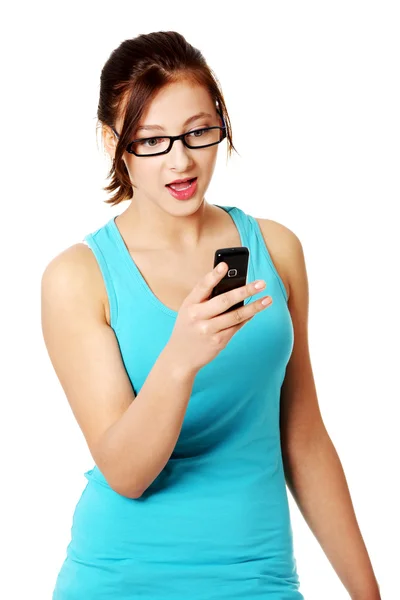 Tiener verrast student lezing sms. — Stockfoto