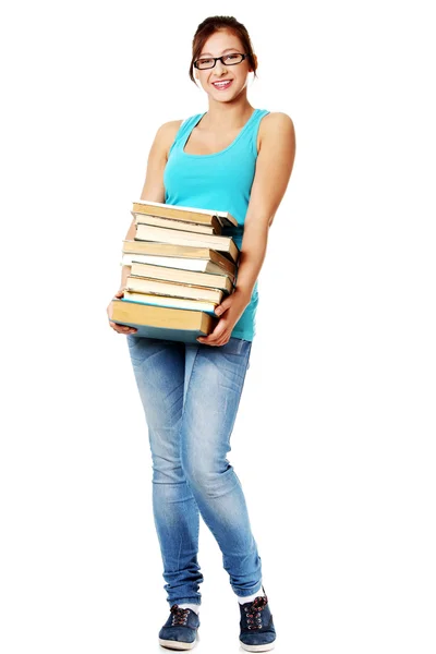 Estudante adolescente sorrindo e segurando livros . — Fotografia de Stock