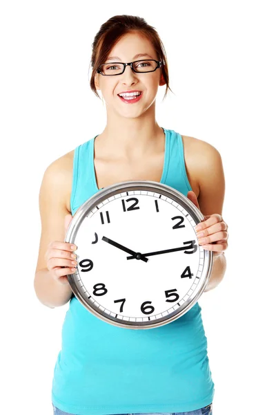 Young smiling girl holding a clock. — Stock Photo, Image
