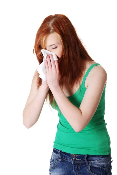 Teen girl blowing her nose. — Stok fotoğraf