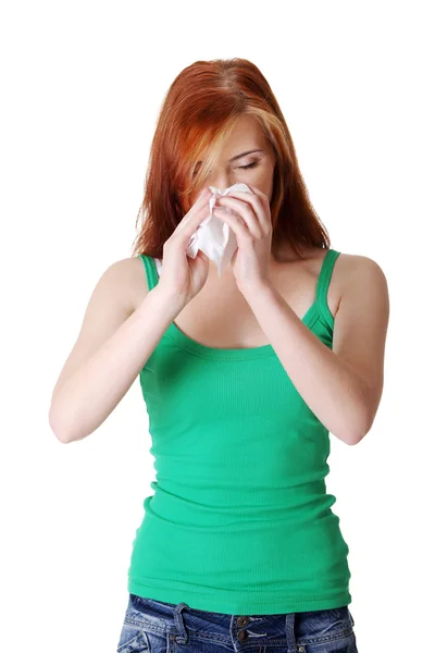 Teen girl blowing her nose. — Stockfoto