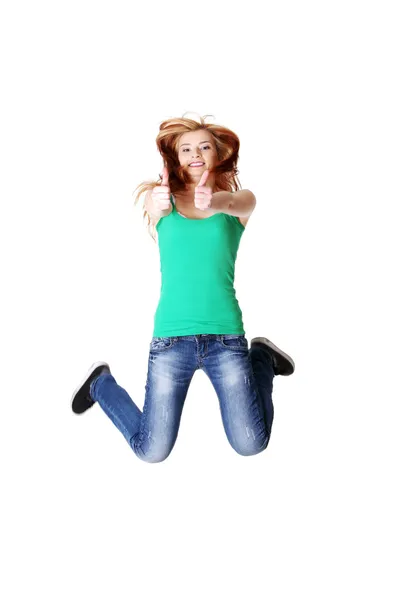 Saltando adolescente estudante mostrando gesto ok — Fotografia de Stock