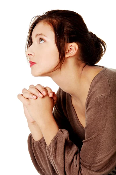Chica joven rezando y mirando hacia arriba . Fotos de stock libres de derechos