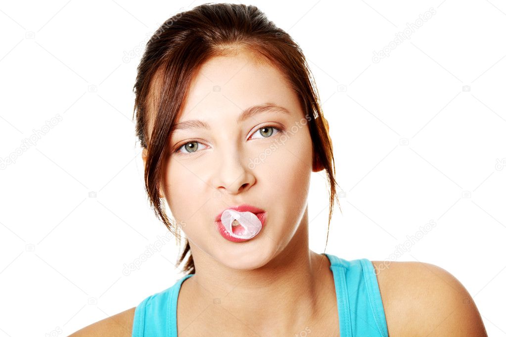 Teenage girl trying to do a bubble from her gum.