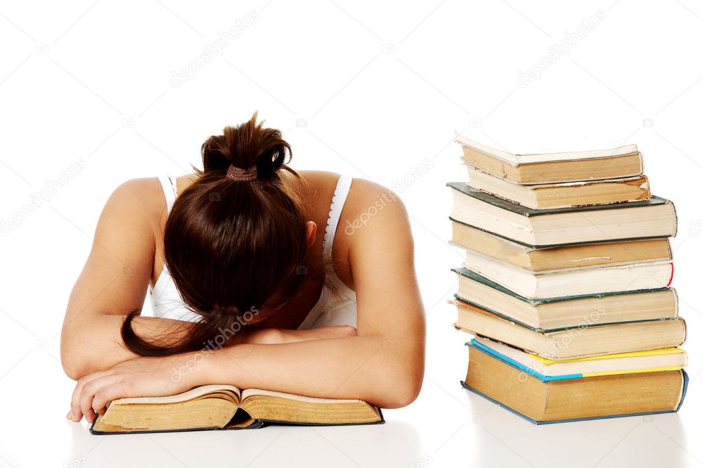 Young girl sleeping on the book.
