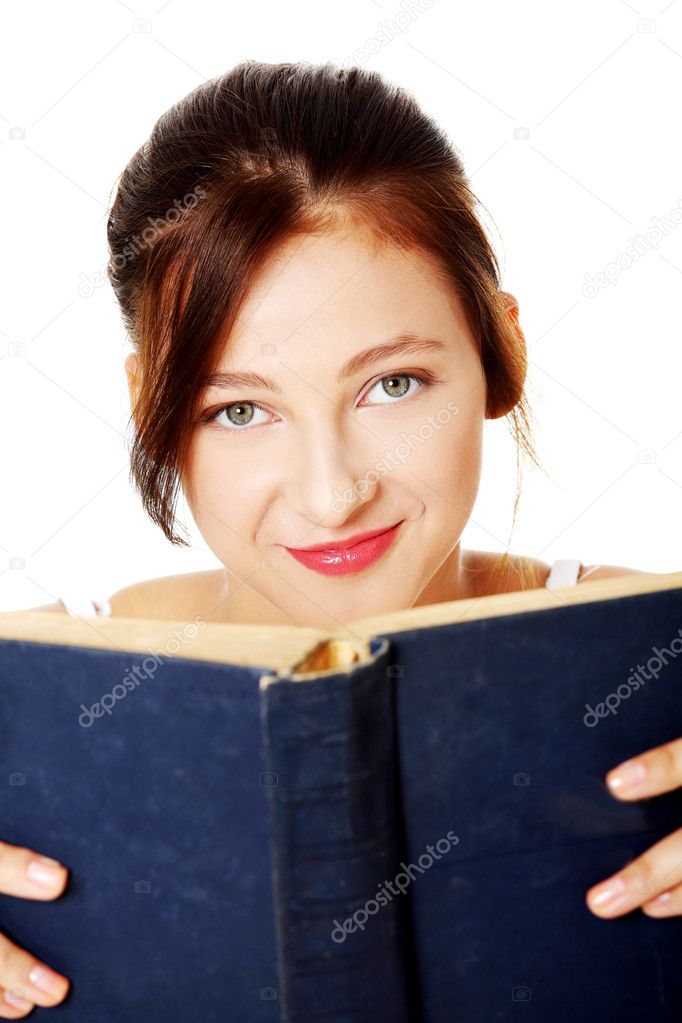 Closeup on smiling girl holding open book.