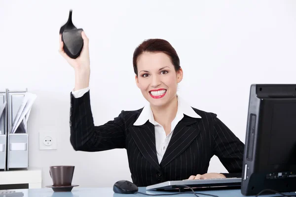 Mad businesswoman throwing her shoe. — Stock Photo, Image