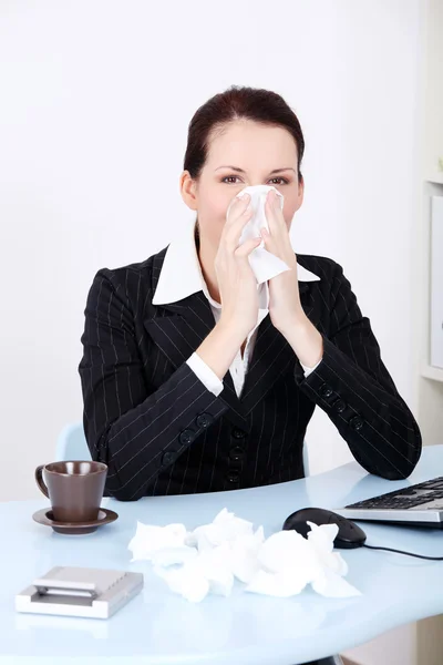 Businesswoman blowing her nose. — Stock Photo, Image