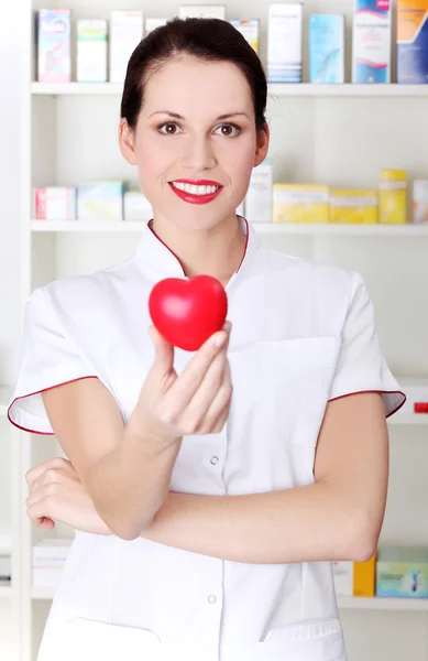 Pharmacist holding heart. — Stock Photo, Image