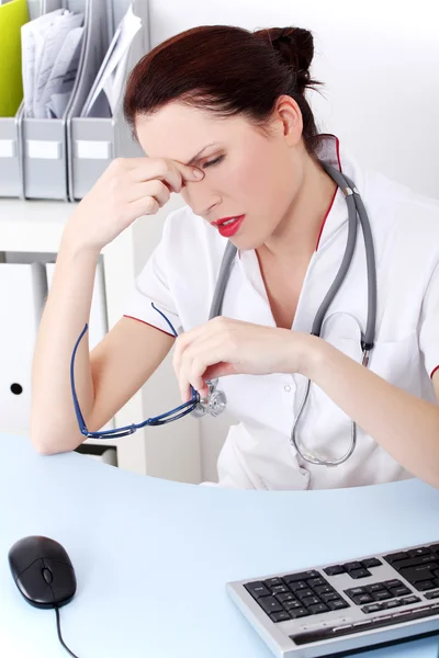 Female doctor having headache. — Stock Photo, Image