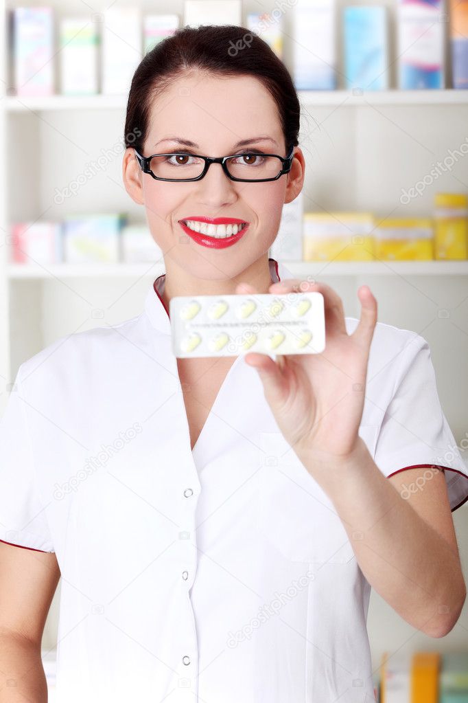 Pharmacist showing pill blister.